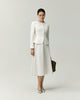 Model wearing the Naya A-line skirt in white with a matching white jacket